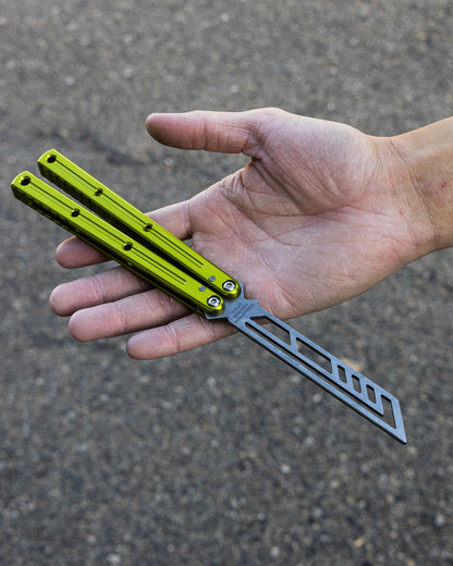 Electric Lime Krake Raken in open position on hand blurry background