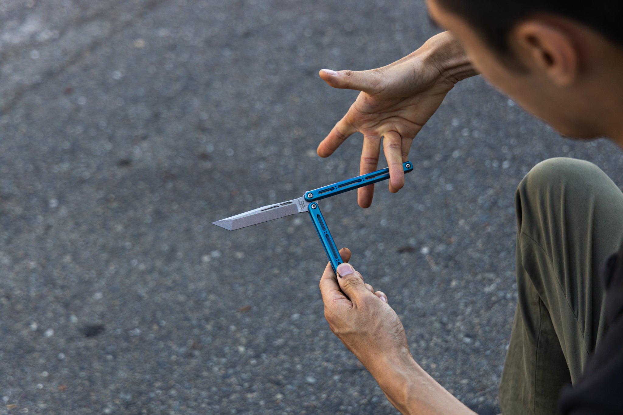 A man flipping a teal hydro live blade