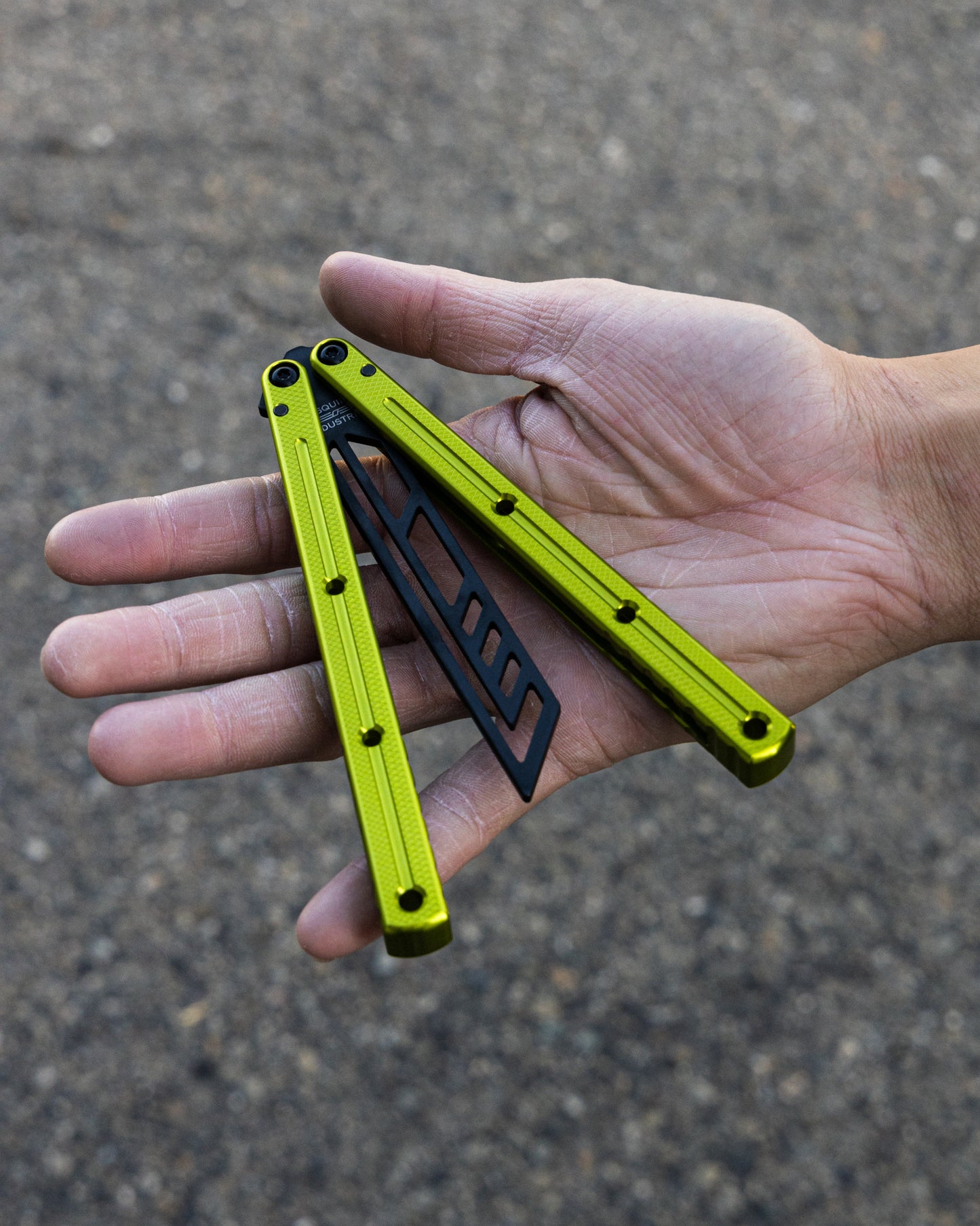 Inked Electric Lime Krake Raken in semi close position on hand blurry background