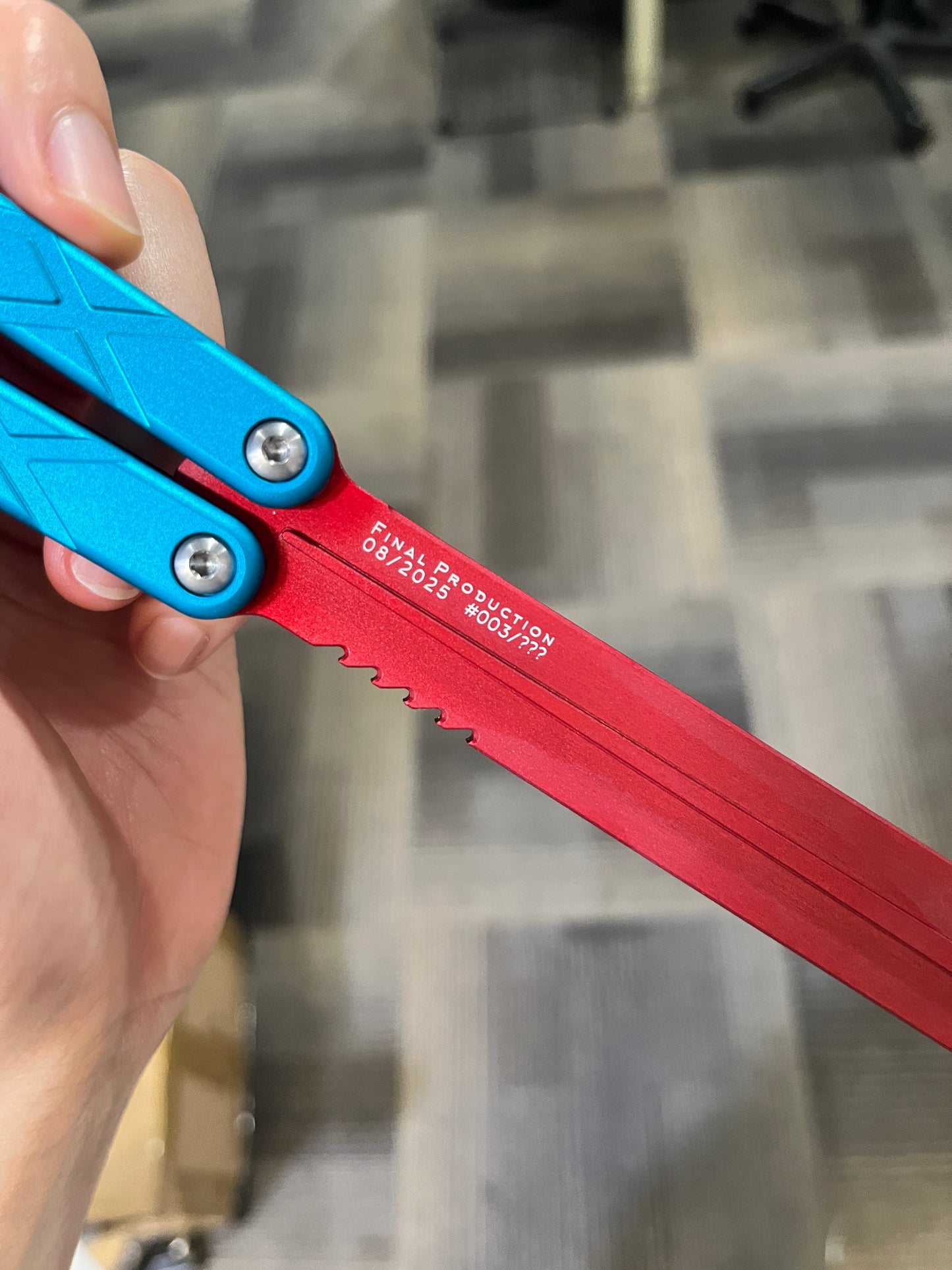 Red and Blue Swordfish with Final Production Engraving held by hand