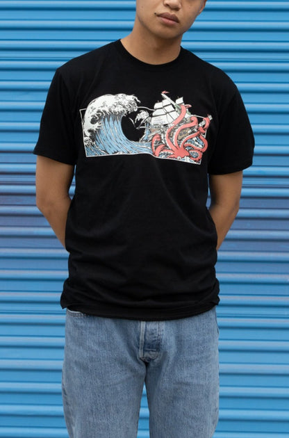 Man wearing Squid Industries x Simple Stock Collaboration T-shirt in black against a blue background