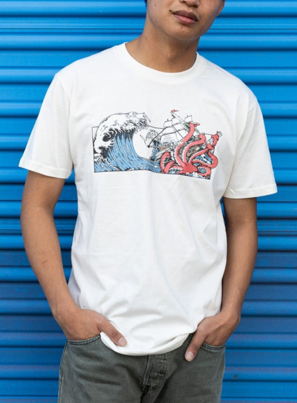 Man wearing a Squid Industries x Simple Stock Collaboration white T-shirt featuring a Kraken in Tsunami waves holding on the Squid Industries balisongs