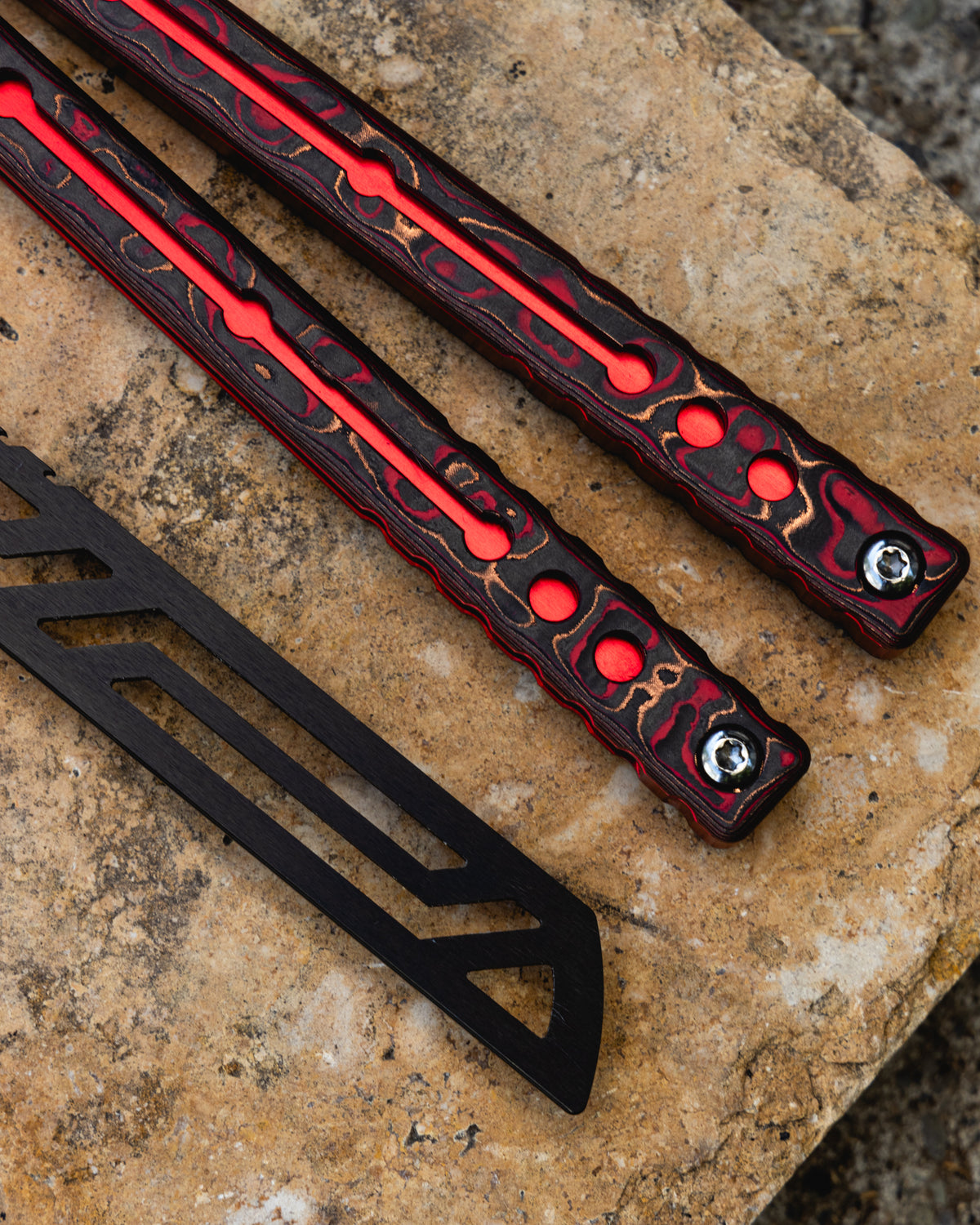 inked redwake handle and blade close up and rocky background